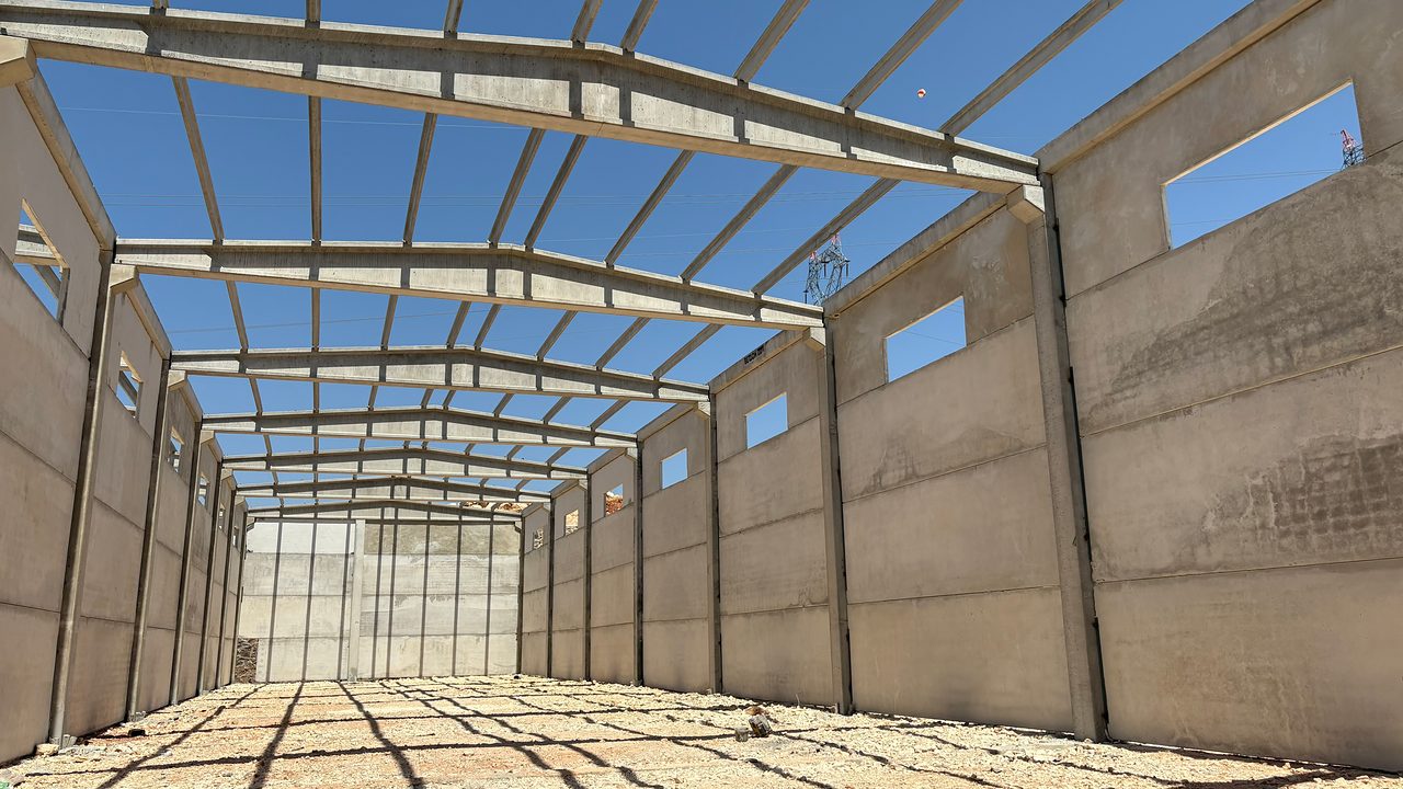 Inside the hall: precast wall panels, window openings and roof girders.
