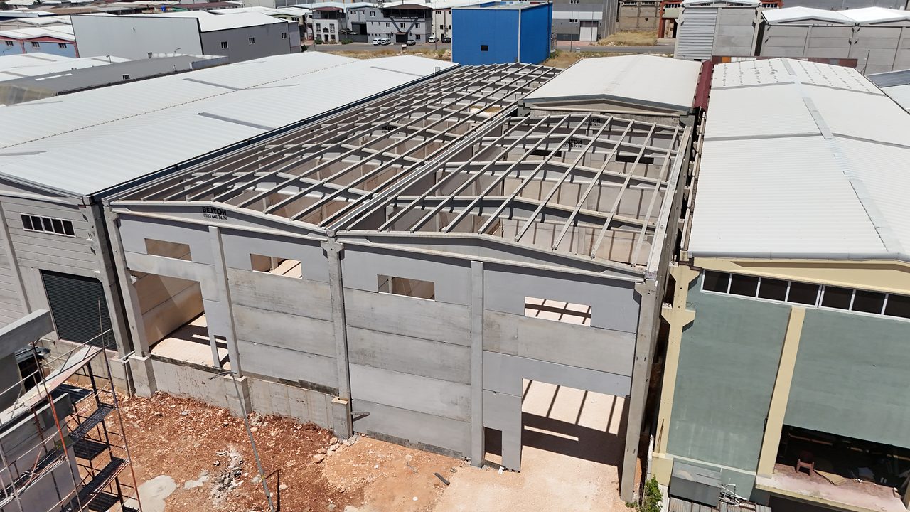 Precast building in a Gaziantep industrial zone: precast facade panels and a roof frame awaiting cladding.